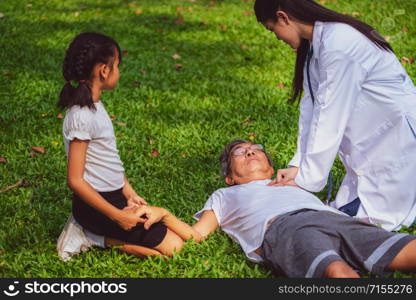 Senior man having chest pain or heart attack in the park. Old people elderly healthcare concept.