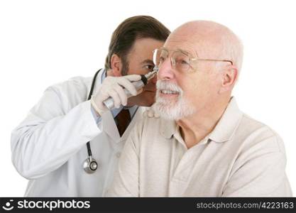 Senior man having his ears checked at the doctors office. Isolated on white.