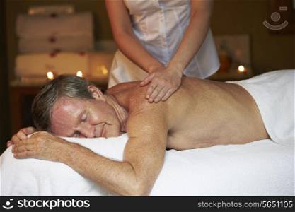 Senior Man Having Massage In Spa