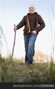 Senior man hiking in a field