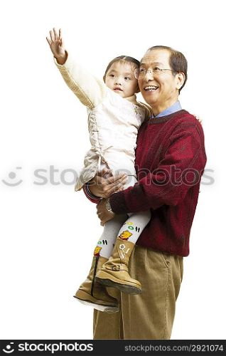 Senior man holding little girl