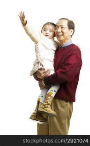 Senior man holding little girl