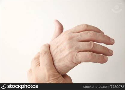 senior man holds his aching hand