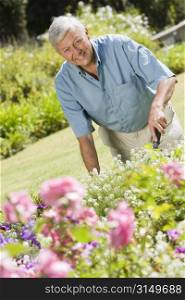 Senior man in a flower garden
