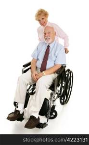 Senior man in a wheelchair with his loving wife pushing him. Full body on white.
