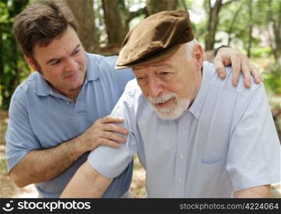 Senior man in failing health and his worried middle-aged son. Focus on Senior man.