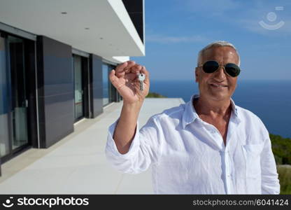 senior man in front of luxury modern home villa