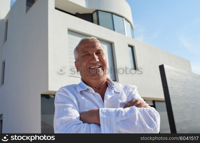 senior man in front of luxury modern home villa