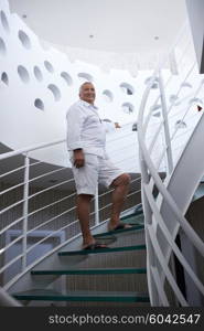 senior man in front of luxury modern home villa