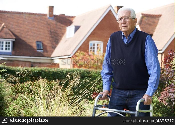 Senior Man In Garden Using Walking Frame