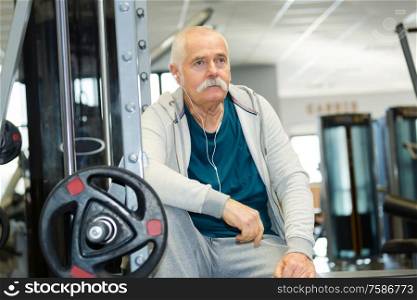 senior man in gym working out