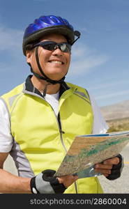 Senior man in sportswear reading map