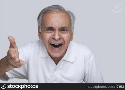 Senior man laughing while gesturing