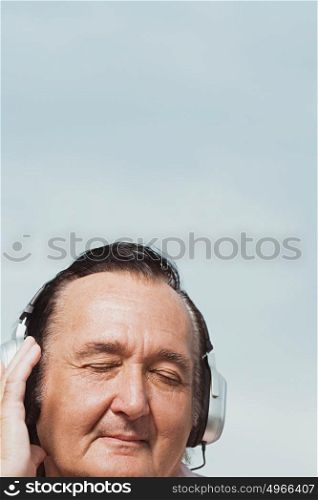 Senior man listening to headphones