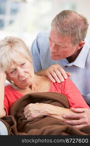 Senior man looking after sick wife