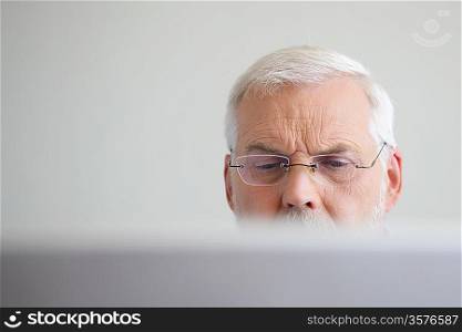 Senior man looking at a laptop