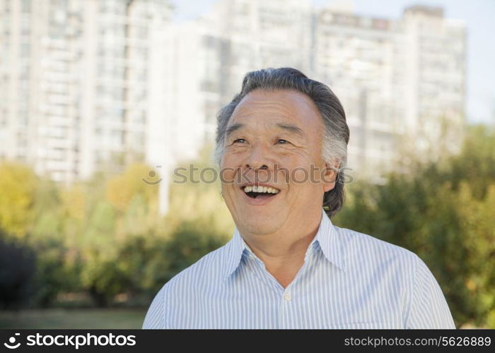 Senior man looking at the sky, portrait