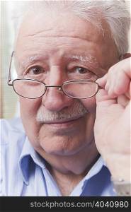 Senior man looking over glasses