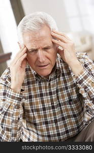 Senior Man Looking Stressed In Chair At Home