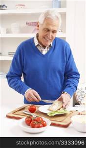 Senior Man Making Sandwich In Kitchen
