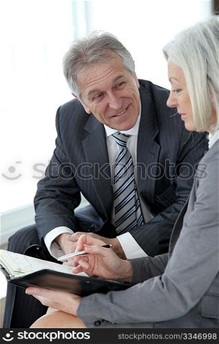 Senior man meeting senior businesswoman