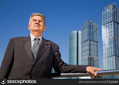 senior man near skyscrapers construction