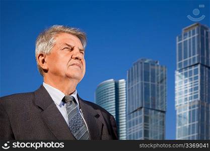 senior man near skyscrapers construction