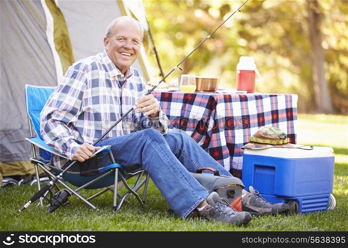 Senior Man On Camping Holiday With Fishing Rod