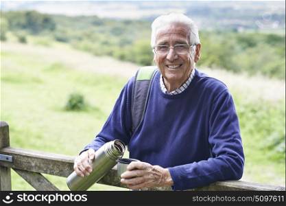 Senior Man On Hike Having Hot Drink
