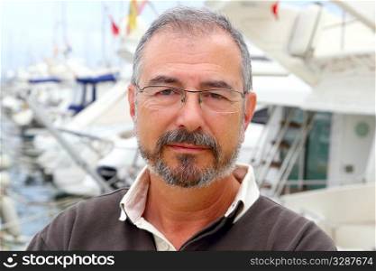 Senior man on marina sport boats portrait happy relaxed