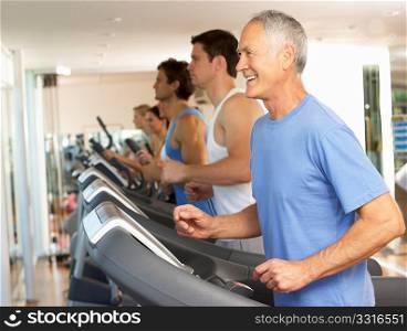 Senior Man On Running Machine In Gym