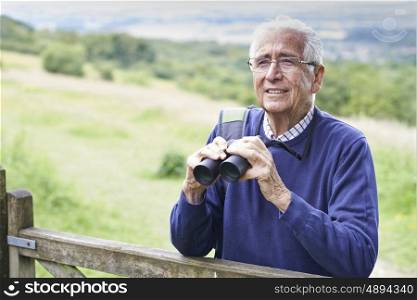 Senior Man On Walk With Binoculars