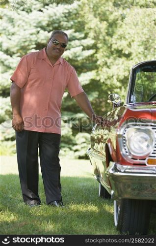 Senior man opening a door of a car