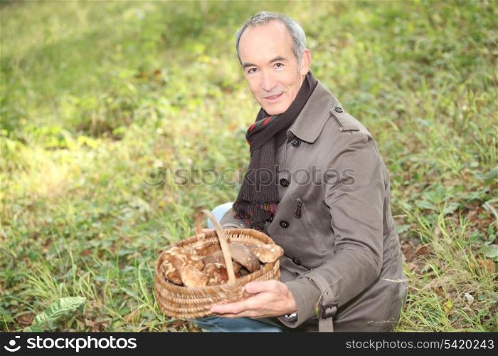 senior man picking mushrooms