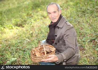 senior man picking mushrooms