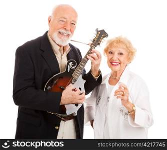 Senior man plays music on his mandolin while his wife sings along. Isolated
