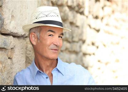 Senior man posing in a panama hat