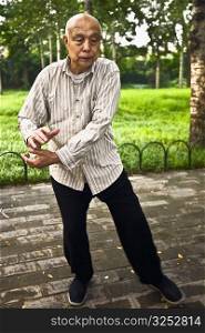 Senior man practicing kung fu, Temple Of Heaven, Beijing, China