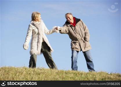 Senior Man Pulling His Wife By The Hand