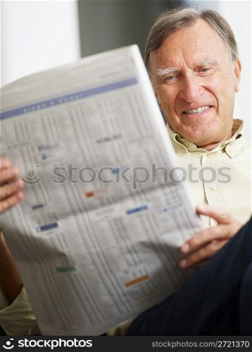Senior man reading stock listings