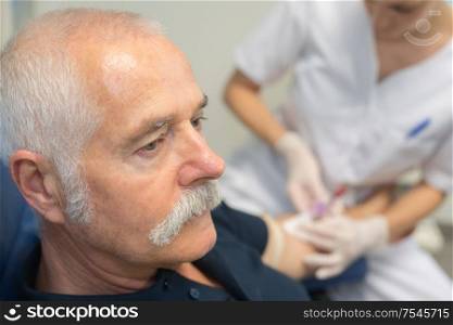 senior man receiving an insulin injection