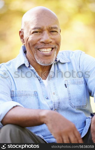 Senior Man Relaxing In Autumn Landscape