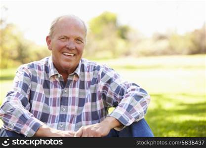 Senior Man Relaxing In Autumn Landscape