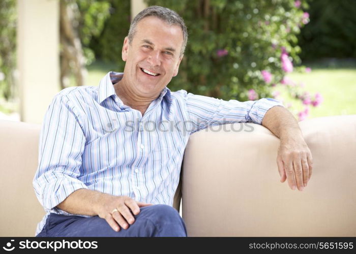 Senior Man Relaxing On Sofa At Home