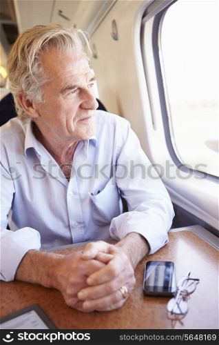Senior Man Relaxing On Train Journey