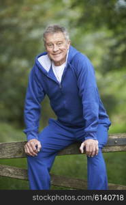 Senior Man Resting Whilst Exercising In Countryside