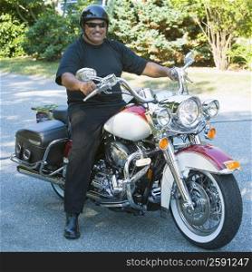 Senior man riding a motorcycle and smiling