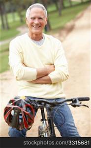 Senior man riding bicycle in park