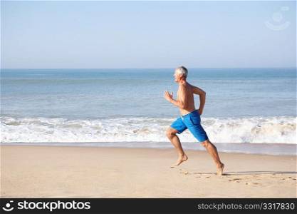 Senior man running on beach