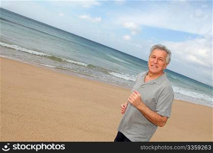Senior man running on the beach